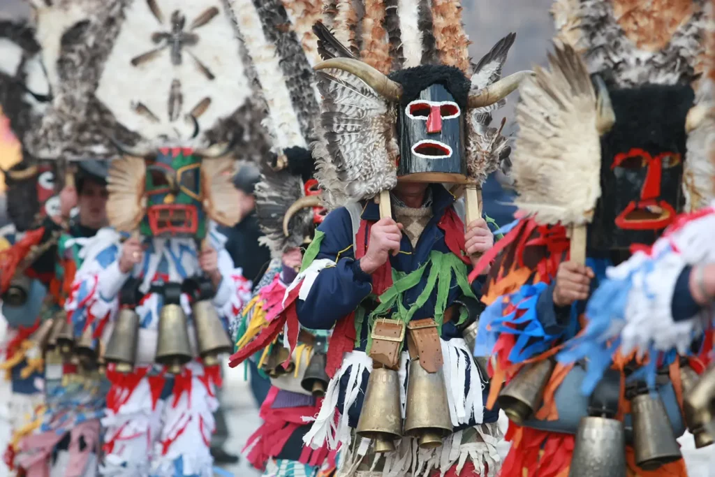 Mask dancers take part in a parade during the the International Festival of Masquerade Games Surva in the town of Pernik.