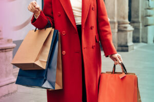 Women's hands hold many shopping bags