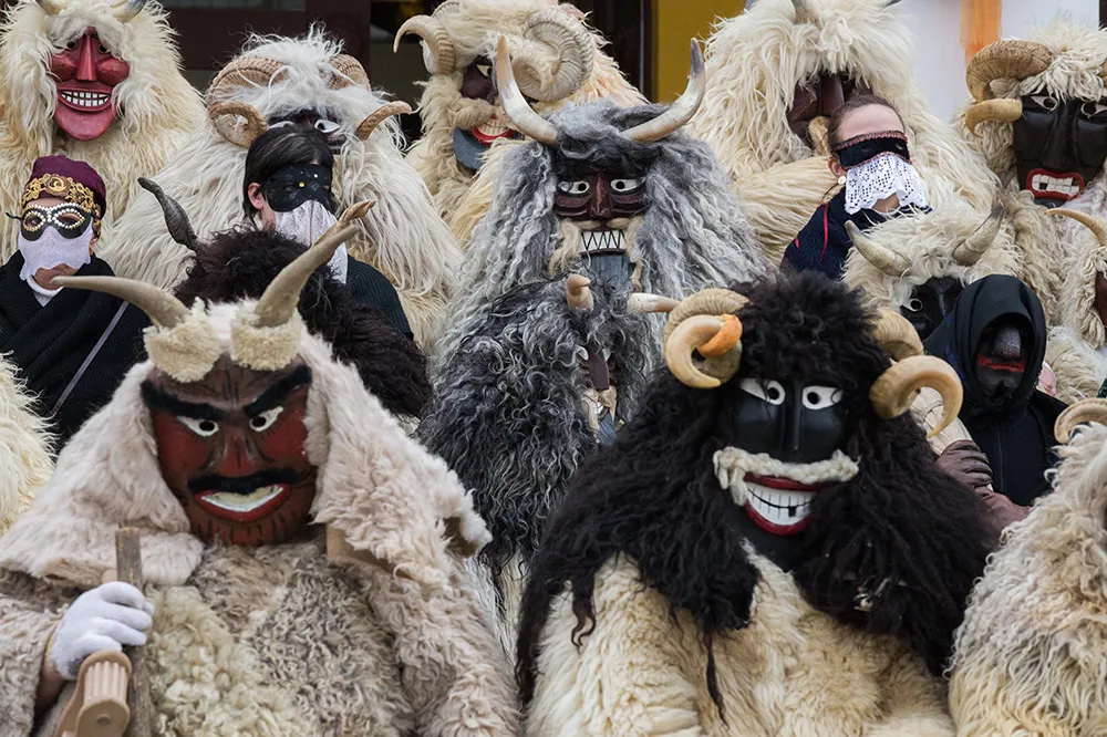 Carnival in Europe - The Busos are dressed in scary-looking costumes, traditionally men wearing wooden masks and big woolly cloaks
