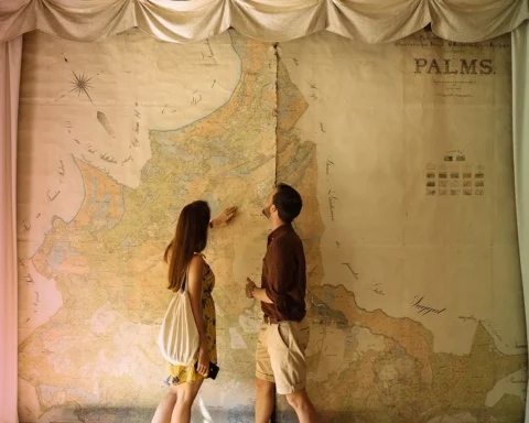 Couple in front of large map of Livonia from The Palmse Manor