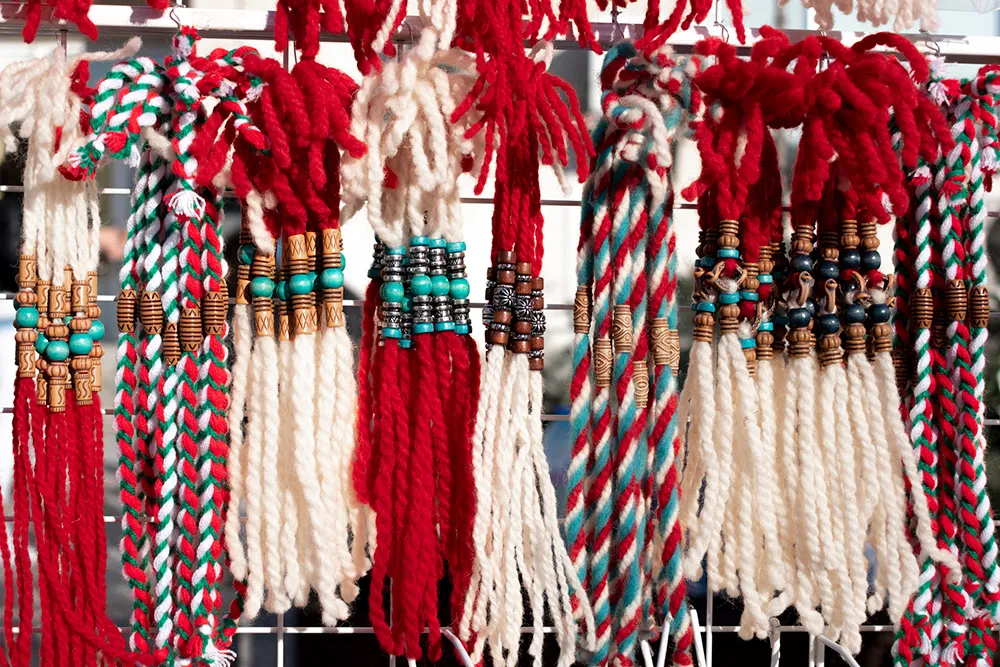 Martenitsa on the street of Plovdiv, Bulgaria. Traditional Bulgarian jewelry made of white and red woolen threads. Celebrating the beginning of spring. Martisor. March 1st concept