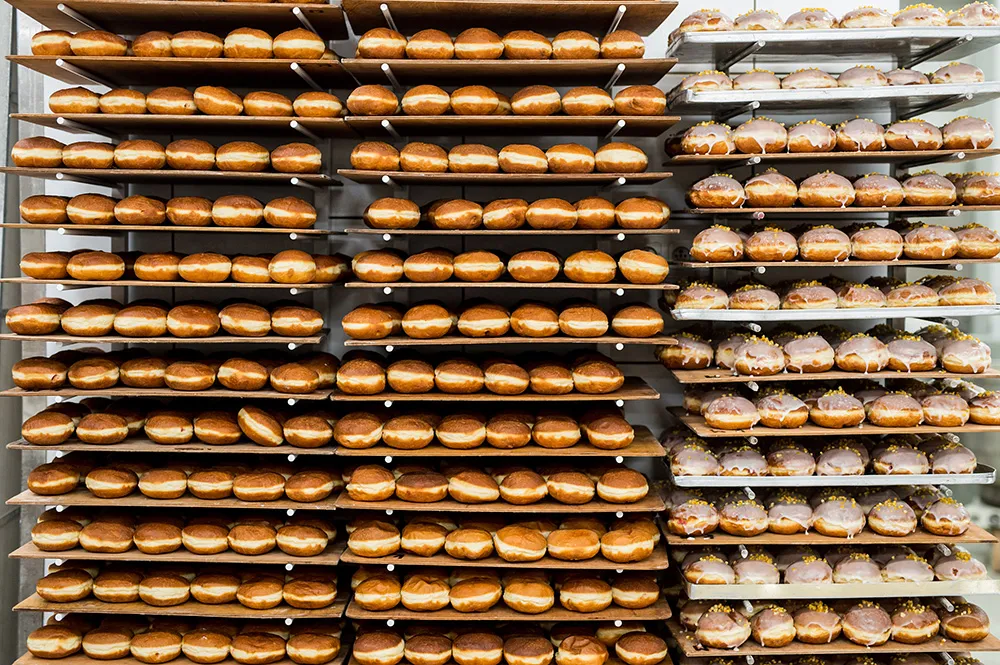 fat thursday in poland - production of doughnuts in a bakery