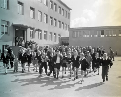 archive photo from 1959 shows students running out of school