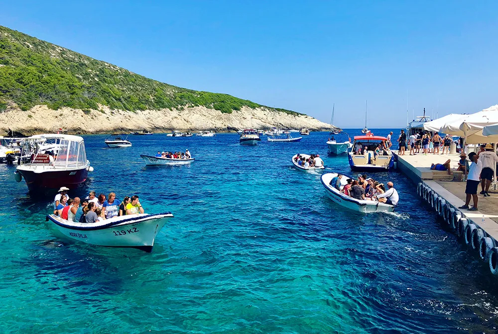 Bisevo island, Croatia. Tourists are loaded onto small boats to be taken to and from the Blue Cave from the island of Bisevo, Croatia