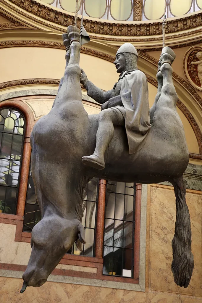 The Anti-Vaclav sculpture representing St. Wenceslas seated on the belly of his dead horse. The sculpture is located in the Lucerna Palace of Prague, Czech Republic