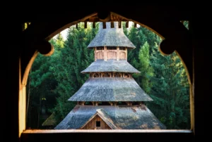 A traditional Romanian wooden monastery surrounded by forest. The image was taken in Maramures, in the far north of Romania, and probably the most traditional region. Horizontal color image with copy space