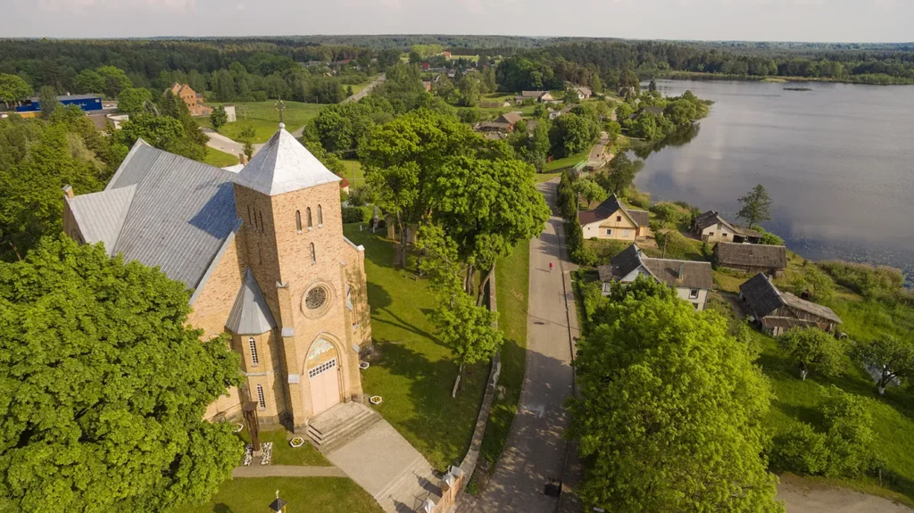 Beautiful summer shot of Vepriai church and lake from the sky