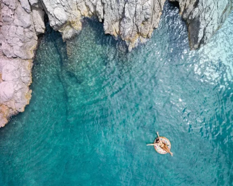 Woman swimming in beautiful clear water in Croatia