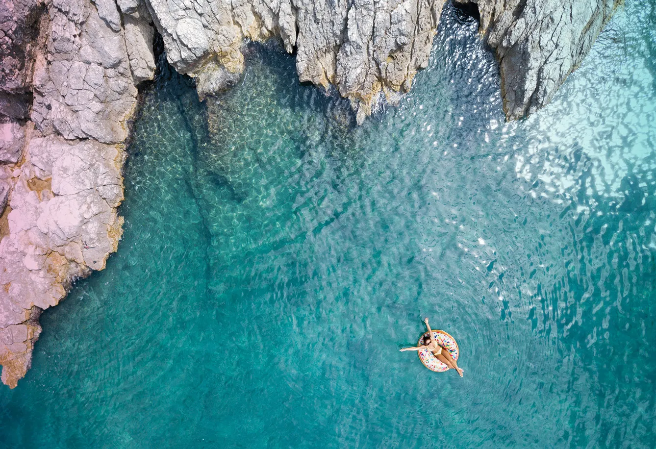 Woman swimming in beautiful clear water in Croatia