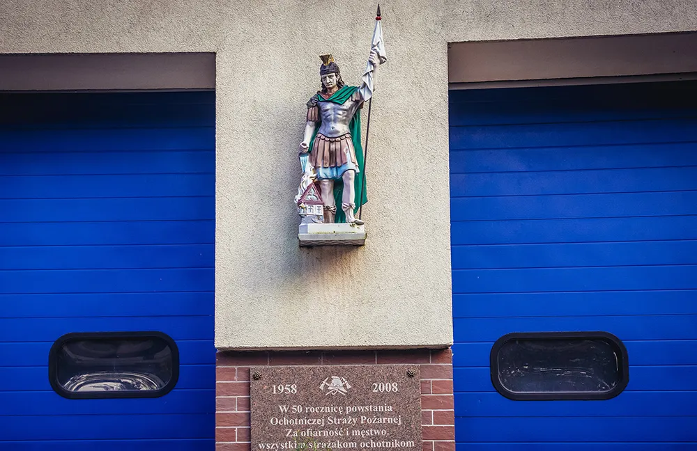 Small statue of St Florian on the wall of fire department building in Laski village, Masovia region of Poland