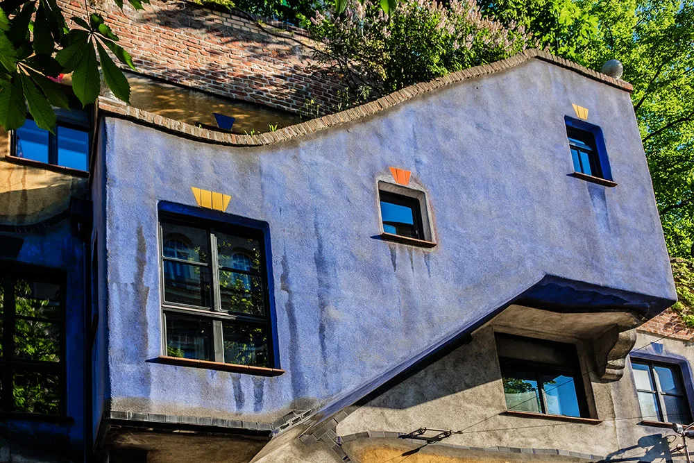Fragments of architecture of Hundertwasser House - famous apartment house in Vienna built after idea and concept Austrian artist Friedensreich Hundertwasser
