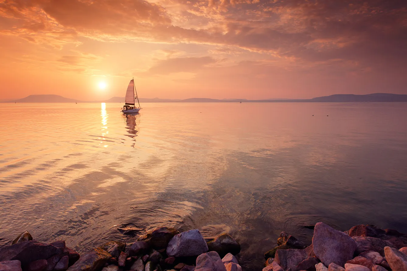 sailboat on the lake at sunset. Location: Lake Balaton, Hungary
