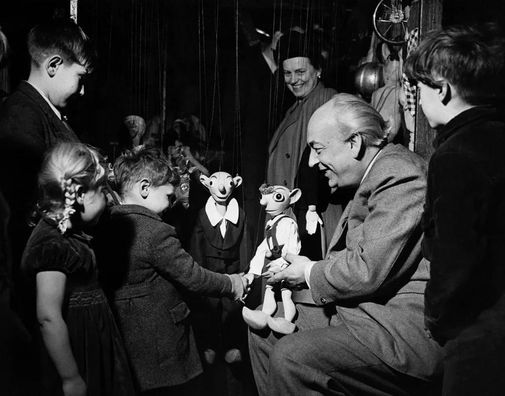Professor Skupa and his Puppets. Professor Skupa, founder of the Czechoslovak Puppet Theatre shows his puppets Hurvinek and Spejbl to some children in London. During the war he was imprisoned, by the Gestapo, and the toys were kept in their criminal archives