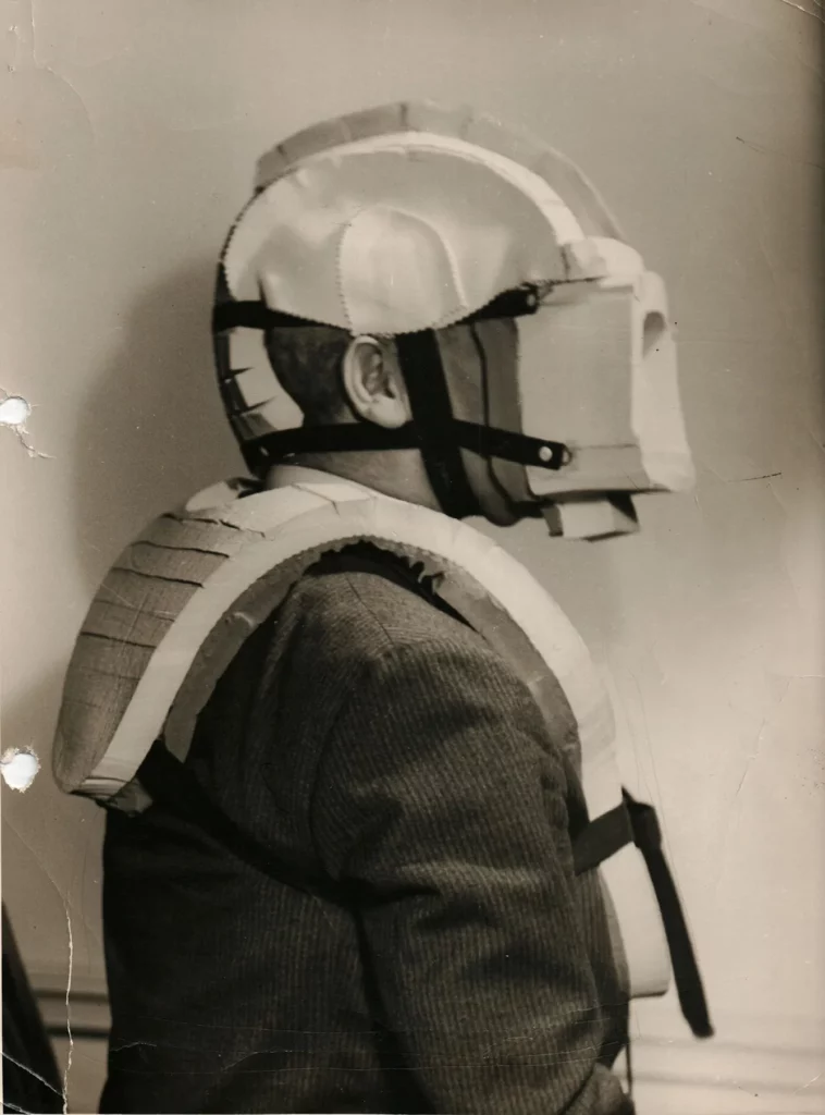 Assen Jordanoff testing a mask of his model and rescue clothing.