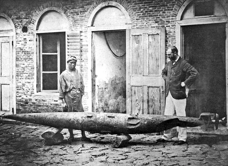 Robert Whitehead (right) with a rather battered test torpedo, Fiume, c1875. His son John is at left.