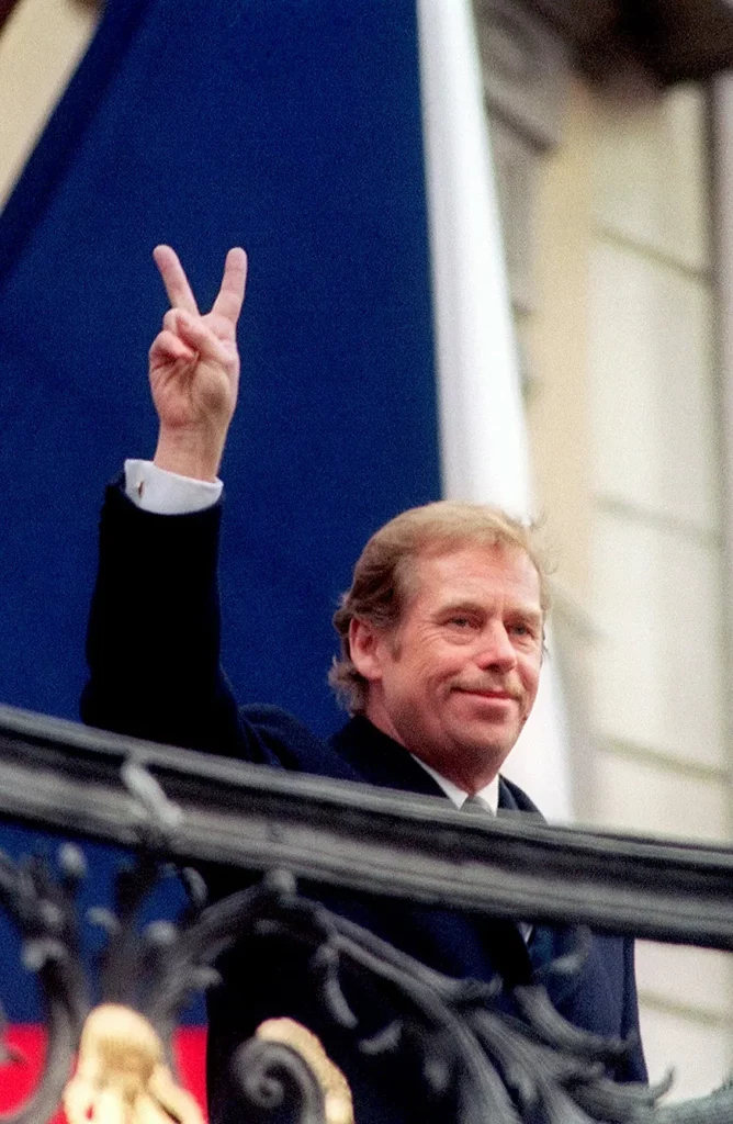 Standing on a balcony of Prague's castle, playwright Vaclav Havel flashes a victory sign to a crowd of thousands after her was elected President of Czechoslovakia on Friday , Dec. 29, 1989
