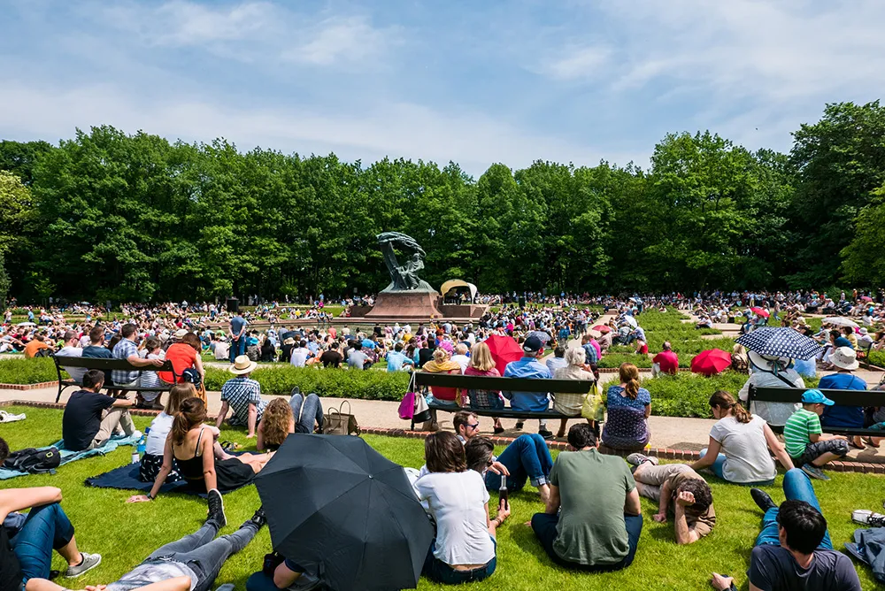 People enjoying the open piano concert in the Lazienki park as a tribute to Chopin, in Warsaw, Poland
