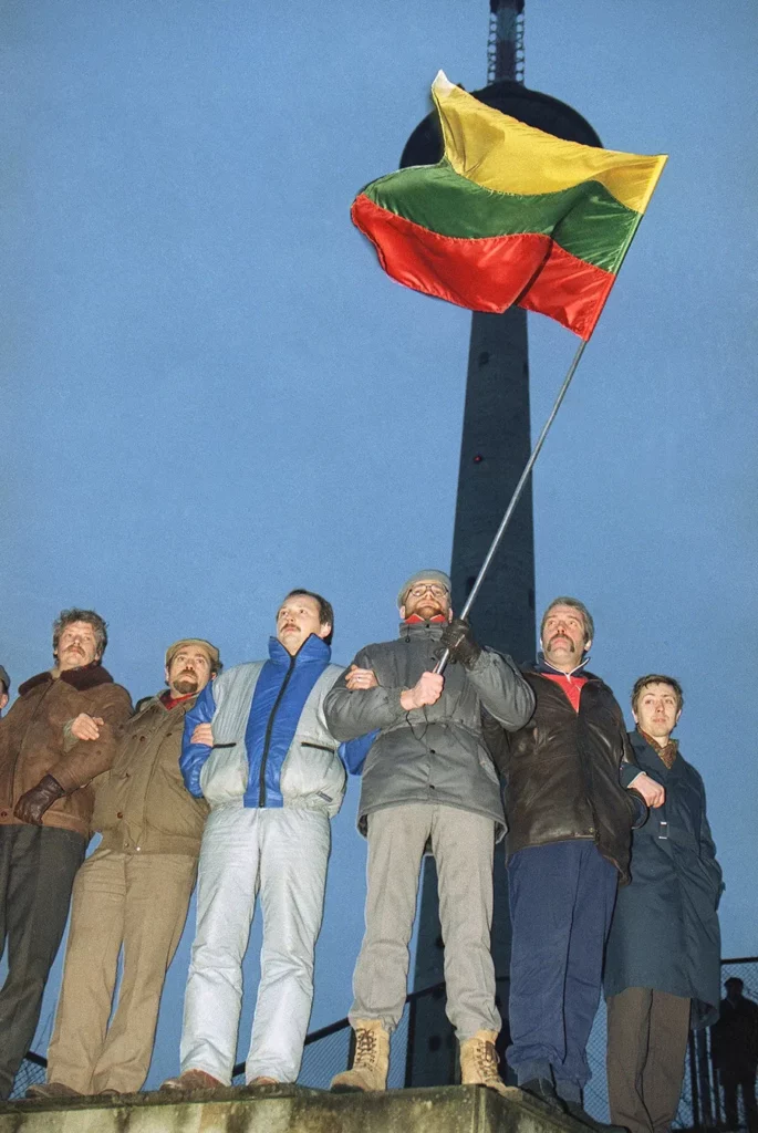 Lithuanians wave the republicbs flag while they stand in front of the television transmitting tower in Vilnius on Thursday, Jan. 11, 1991 to guard it against a possible Soviet takeover. Soviet President Mikhail Gorbachev announced on Thursday that he was under increasing pressure to crack down on the Baltic Republic if it continues on its drive for independence.