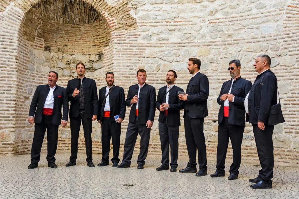 Traditional dalmatian klapa singers , performing under the cathedral dome in Split