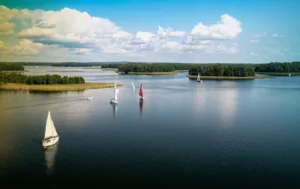 Aerial view of green islands and clouds at summer sunny day. Masurian Lake District in Poland
