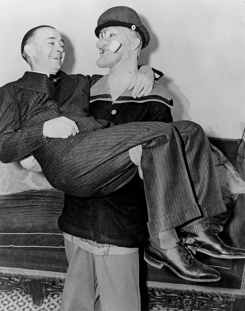 American cartoonist E. C. Segar being carried by actor Harry Foster Welch as an incarnation of Segar's most famous creation, the indomitable sailor Popeye, circa 1935.