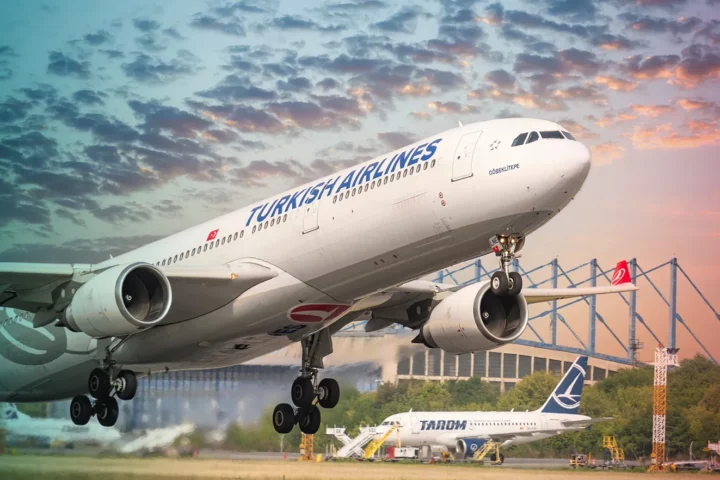 Bucharest, Romania - August 2022: A Turkish Airlines Airbus A330-300 airplane flying against blue cloudy sky. Airplane takes off from Henry Coanda International Airport.
