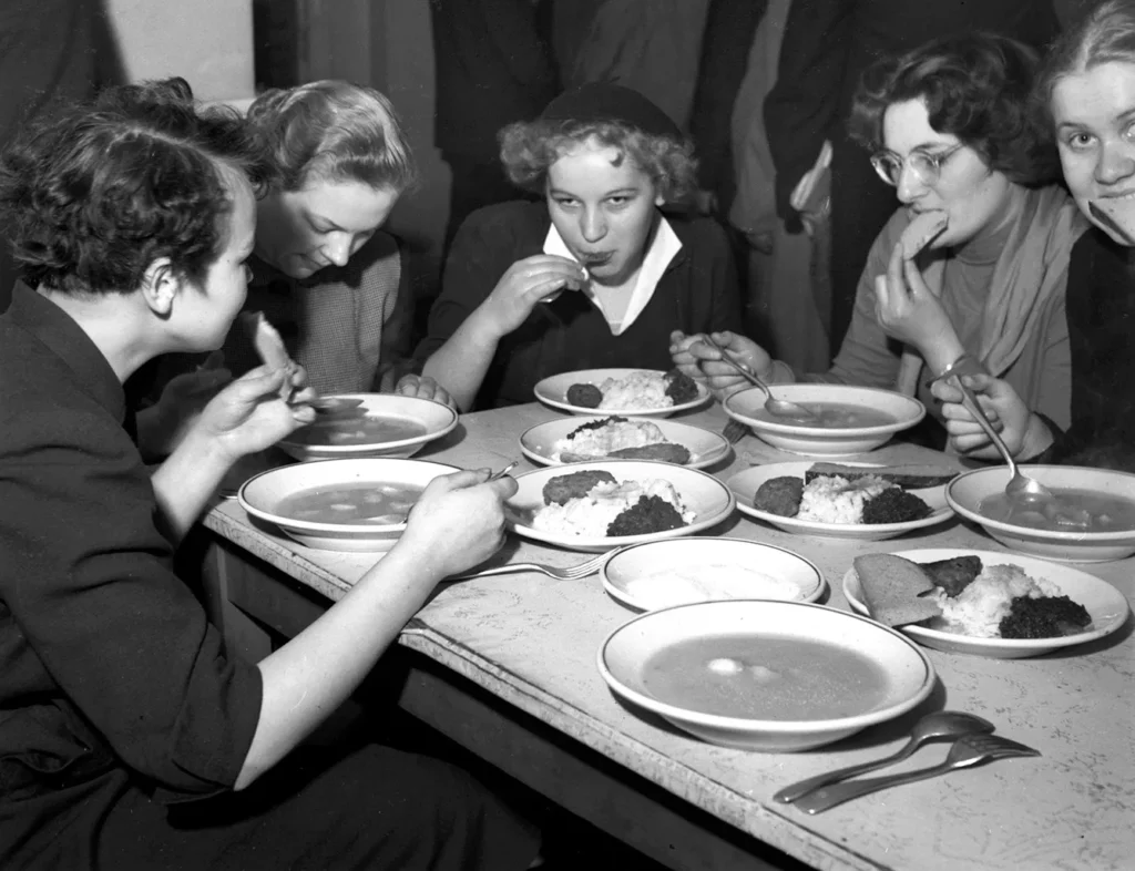 Warsaw, 1950s. female students during a meal at a milk bar