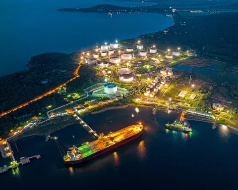 Aerial view of oil tanker ship at the Burgas port at night, import export business logistic and transportation.