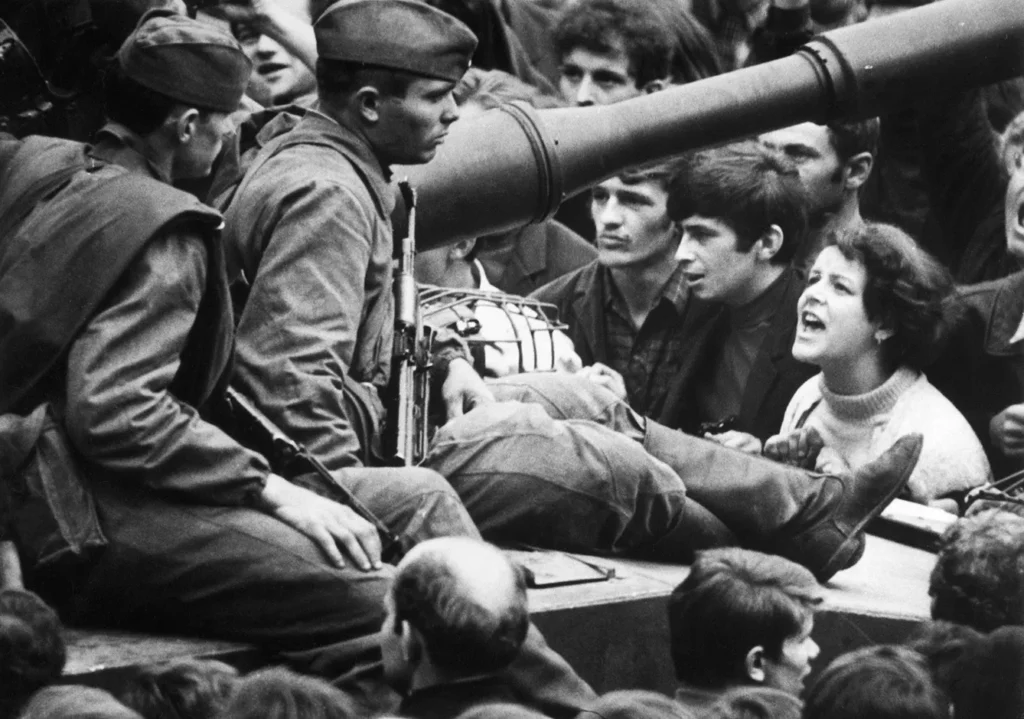 This young Czech girl lets her feelings be known as she shouts "Ivan GO Home!" to soldiers sitting on tanks in the streets of Prague, 8/26/1968
