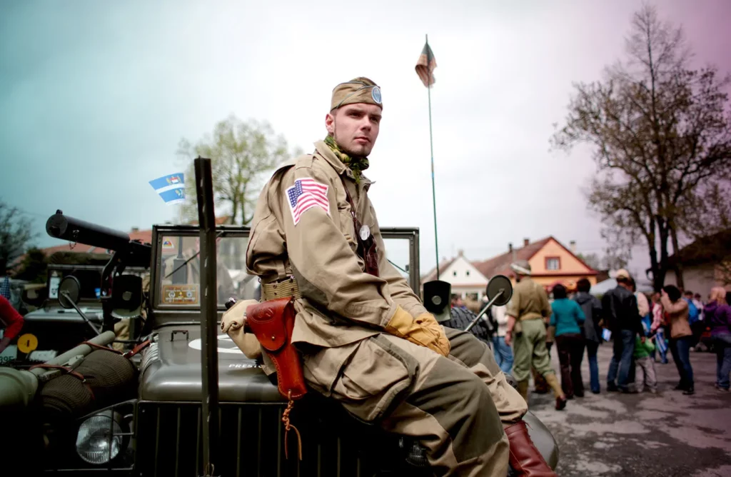 Enthusiasts Commemorate Liberation Of West Bohemia During World War II. DNESICE, CZECH REPUBLIC - MAY 04: A history enthusiast dressed in WWII U.S. Army uniform poses during stop over the 'Convoy of Liberty' event which drive through west Bohemian cities and villages near Pilsen on. May 4, 2013 in Dnesice, Czech Republic. 'Convoy of Liberty' commemorates the 68th anniversary of the World War II ending in Europe and when in 1945 the western part of the Czech Republic was liberated by the U.S. Army from Nazi oppression.