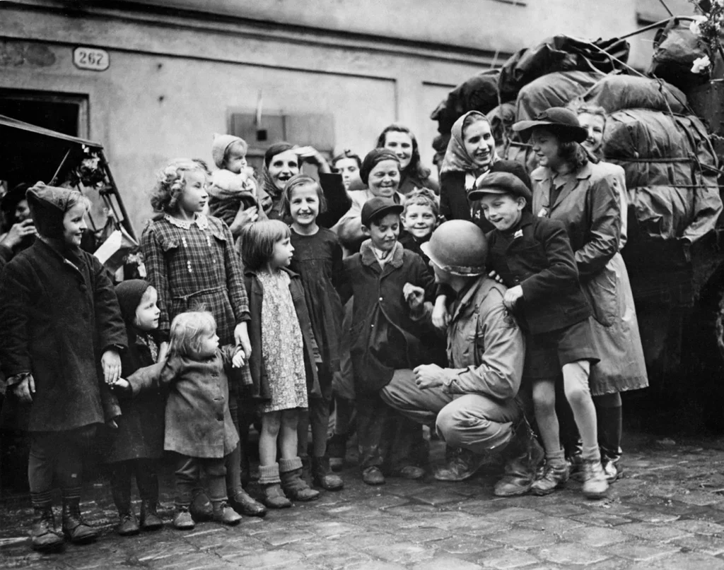 Children of Pilsen (Czechoslovakia) crowd around a soldier of the 3rd US, Army shortly after the town was liberated May 6, 1945.