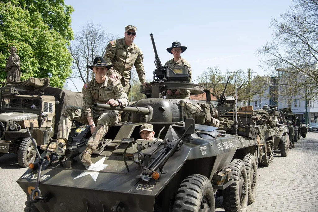U.S. Soldiers assigned to Bull Troop, 2nd Cavalry Regiment, pose on an M8 Greyhound during the Pilsen Liberation Festival, May 6, 2023. The Liberation Festival is an annual event that brings over 50,000 spectators to Pilsen for the Liberation Parade, which consists of U.S. GI reenactors from Czech Republic, Slovakia, Poland, Germany, and the United States to commemorate the 16th Armored Division’s liberation of Pilsen on May 5th, 1945, three days before VE-Day.