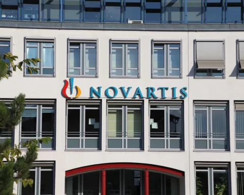 Nuremberg, Germany - September 30, 2012: Novartis neon sign on office building facade on a clear sunny day. Novartis is a Swiss Pharma Concern working international.