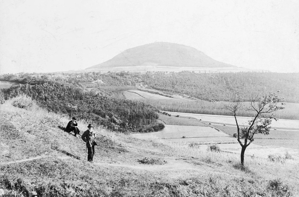 Two men pose in a field beside Rip Hill, 1907. According to legend the first Czechs arrived here.