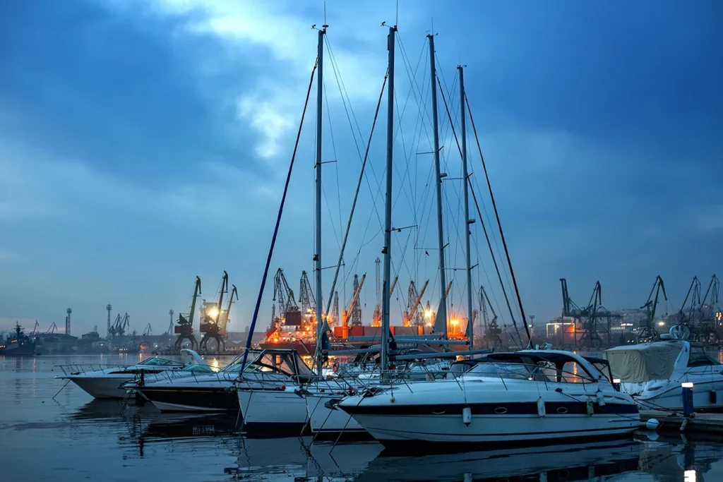 Yachts and boats after sunset in the harbor. Black sea, Varna, Bulgaria.
