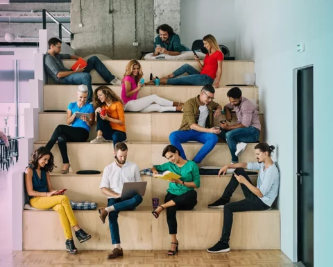 Large group of people networking in a loft office stock photo.