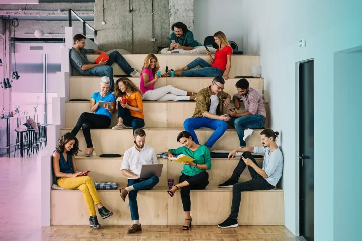 Large group of people networking in a loft office stock photo.