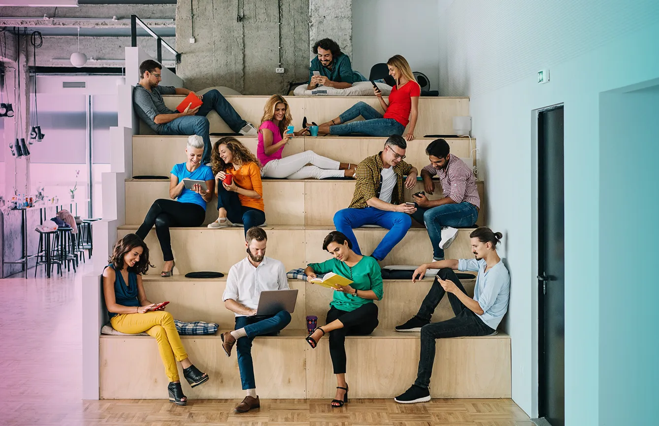 Large group of people networking in a loft office stock photo.