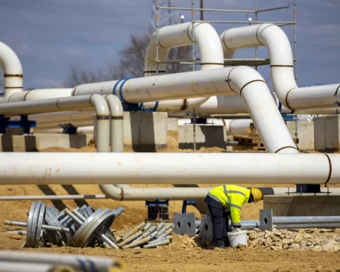 Worker works on a construction site of an interconnected natural gas transmission pipeline.