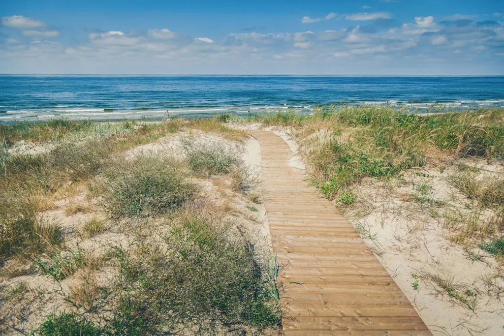 Wooden walkpath to the beach on a Baltic sea in Curonian Spit, Lithuania.