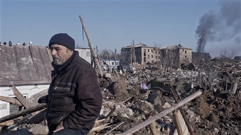 A Mariupolis resident shows his bombed-out apartment at 29 Kuindzhi Street.