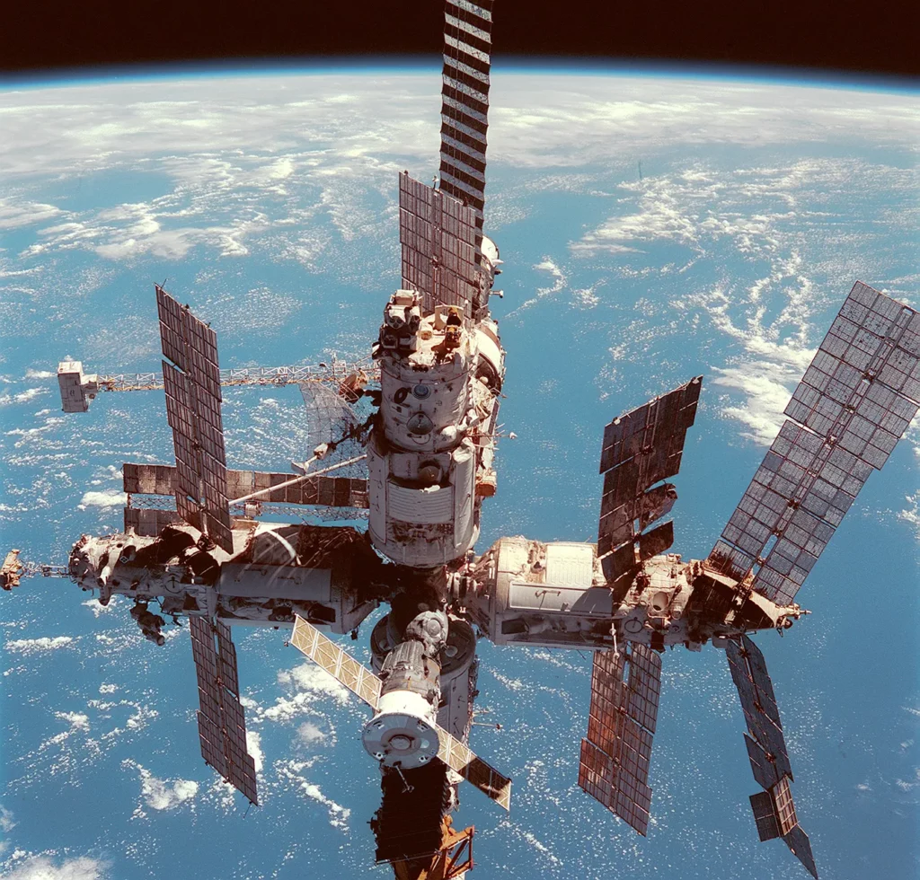 Russia's Mir space station is backdropped over the blue and white planet Earth in this medium range photograph recorded during the final fly-around of the members of the fleet of NASA's shuttles.