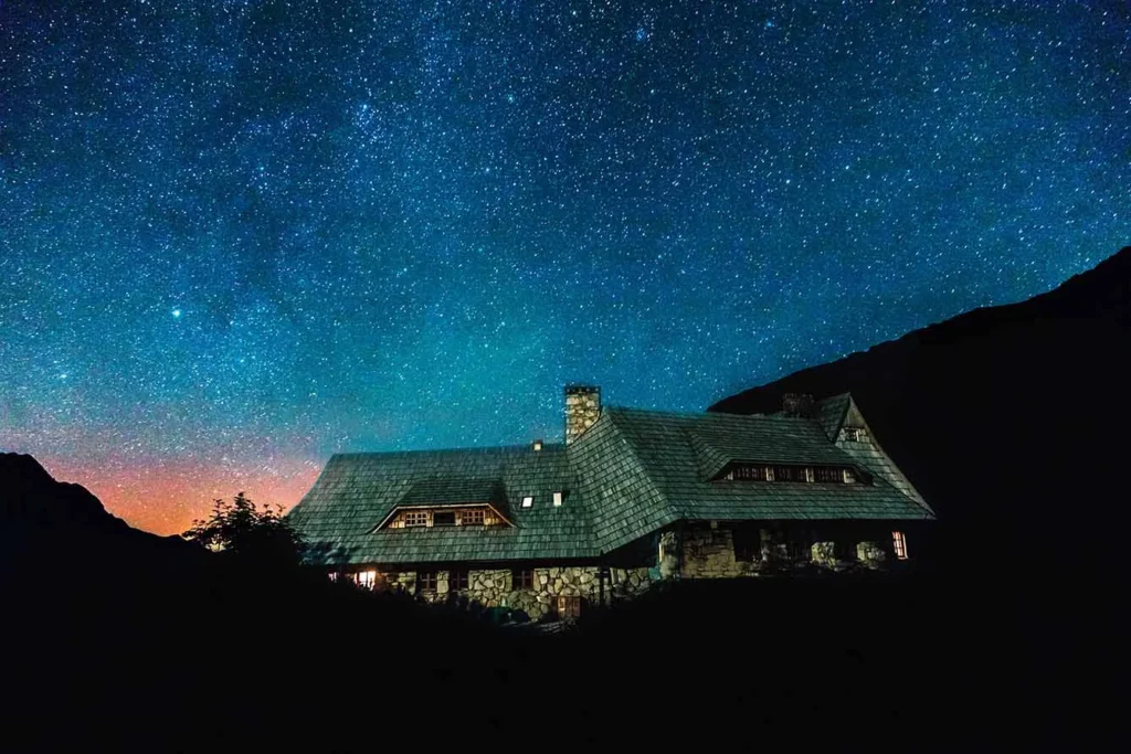 Shelter for tourists in Tatras Mountains at night under star sky, Poland, Dolina 5 Stawów, Zakopane.