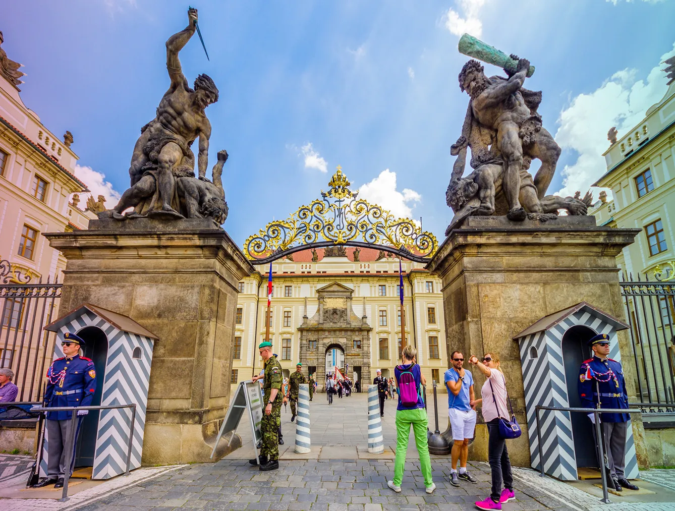 Tourists in front of the Giants Gate (aka Wrestling Giants) in Prague Castle. Prague, Czech Republic