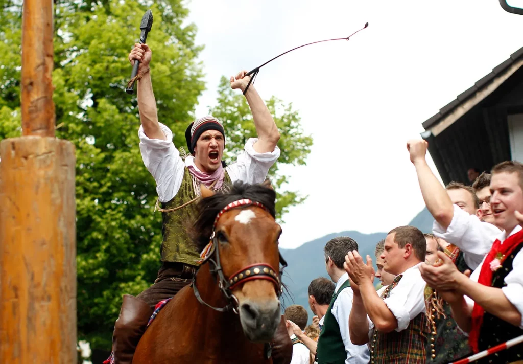 A man participates in village celebrations in Feistritz an der Gail, in the Austrian province of Carinthia, May 28, 2012. The annual celebrations are centered around an alpine farming custom called "Kufenstechen" which, according to the first written records, dates back to 1630. In turn the unmarried young men ride bareback on Noriker horses, beating a wooden barrel with an iron club until the last wooden splinter has fallen down, followed by a dance "under the lime trees" with the unmarried women wearing traditional "Gailtaler" costumes.